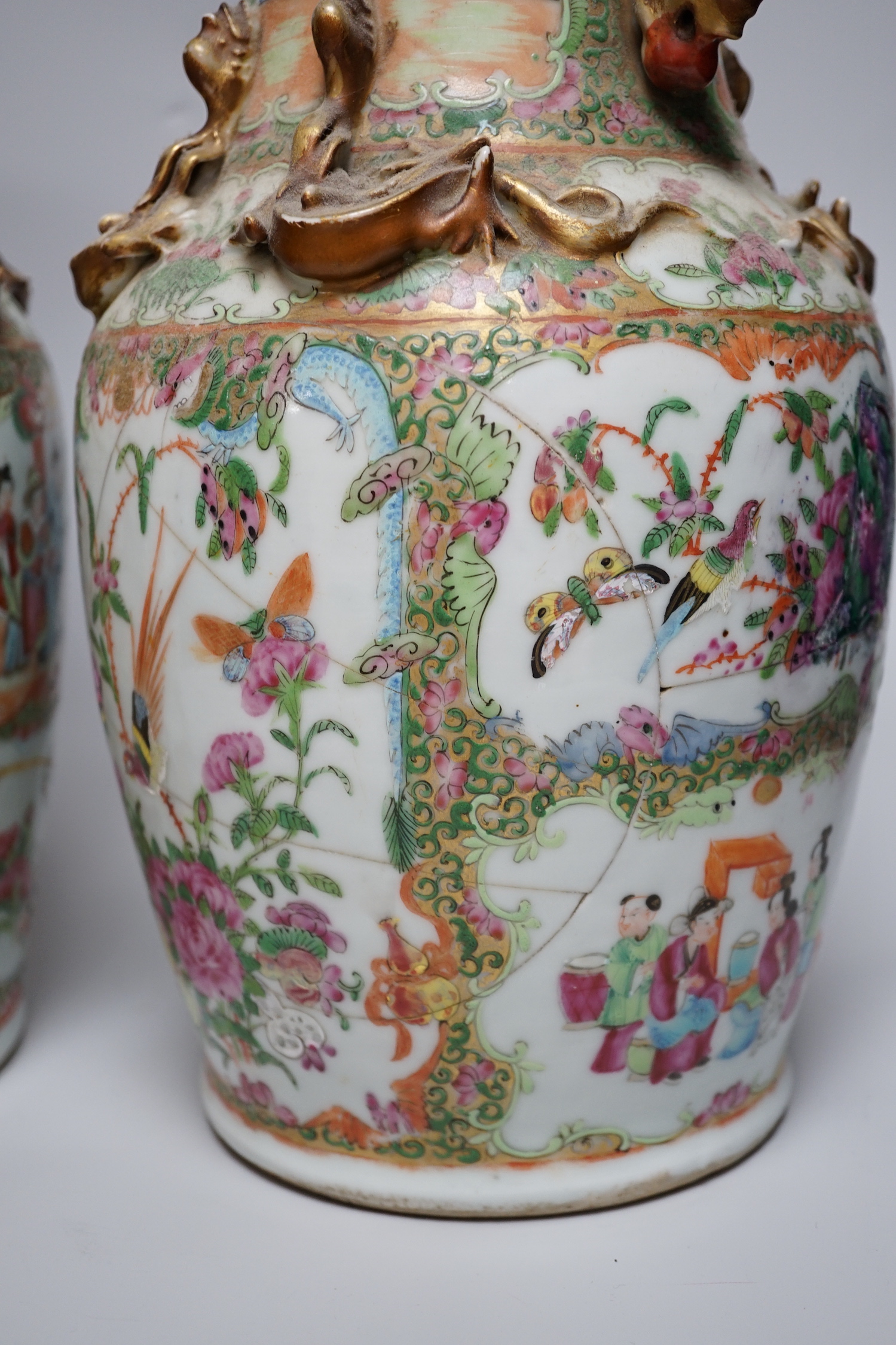 A pair of Chinese Canton decorated famille rose enamelled vases, 36cm high, an early 20th century Chinese blue and white baluster vase, 25cm (a.f.), a 19th century Chinese blue and white gu shaped vase, 37.5cm (a.f.), a